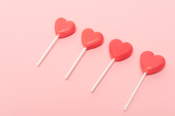heart shaped lollipops on pink background - Photo, Image