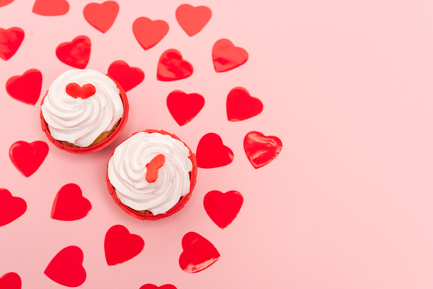 top view of red hearts and cupcakes on pink - Photo, Image