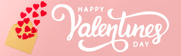 ylhäältä näkymä punainen paperi sydämet ja kirjekuori lähellä onnellista Ystävänpäivä kirjoitus vaaleanpunainen tausta, banneri - Valokuva, kuva