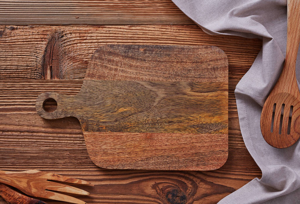 Wooden cutting board on wooden table - Photo, Image