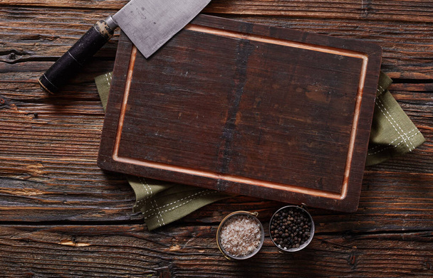 Wooden cutting board on wooden table - 写真・画像