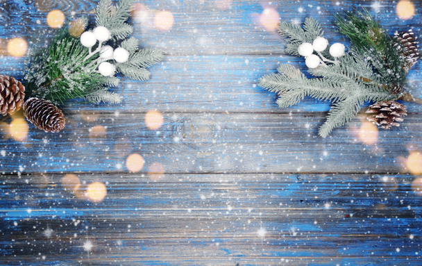 winter christmas background with fir branches cones and snow on blue wooden texture                               - Photo, Image