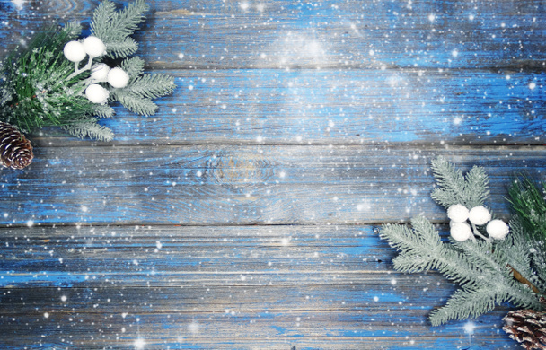 winter christmas background with fir branches cones and snow on blue wooden texture                               - Photo, Image