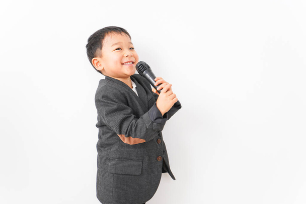 boy Businessman speaking on a microphone - Фото, зображення