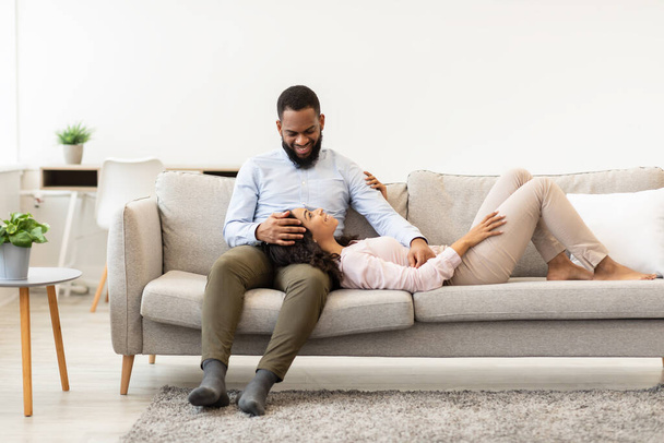 African american couple spending weekend together lying on couch - Photo, Image