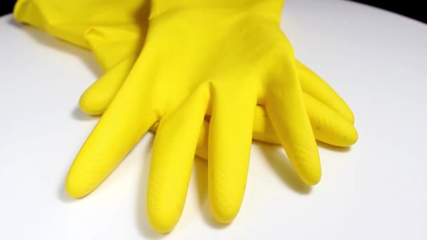 Yellow household gloves on a white background. Turntable. Selective shot. - Footage, Video