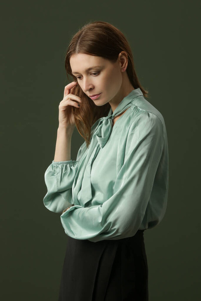 Fashion studio shot of woman in mint green silk satin blouse - Foto, Imagem