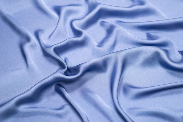 Blue silk or satin luxury fabric texture. Top view. - Foto, imagen