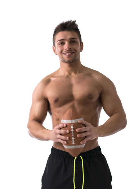 Muscular american football player shirtless with ball in hands - Fotoğraf, Görsel