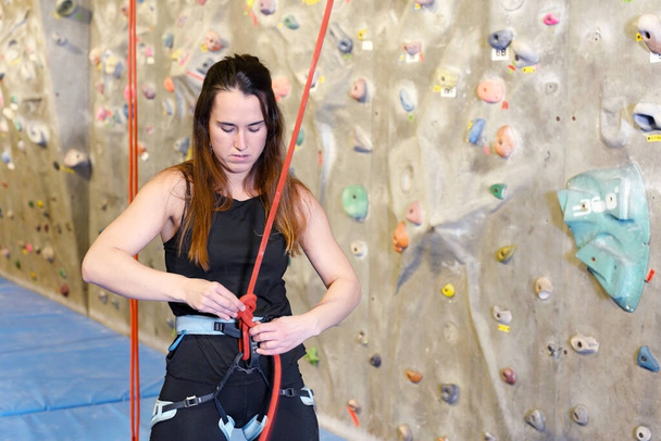 Young fit woman climbing on indoor rock wall.  - Photo, Image