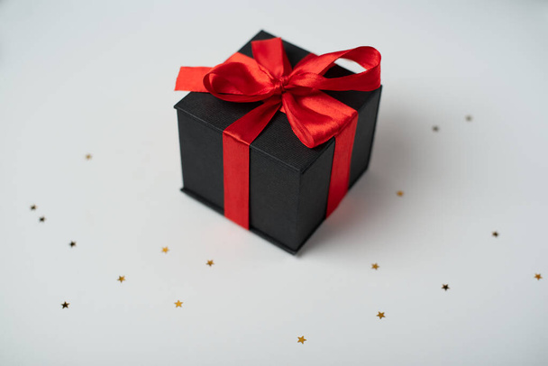 Black gift boxes with red ribbon on white background. The Concept Of Valentine's Day. - Φωτογραφία, εικόνα