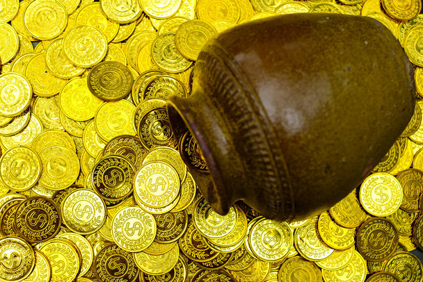 Gold coin in treasure old clay pot on a pile of gold coins - Photo, Image