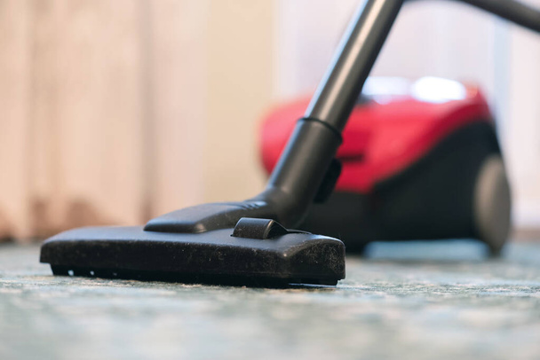 Vacuum cleaner on the floor in the living room close up. - Foto, Bild