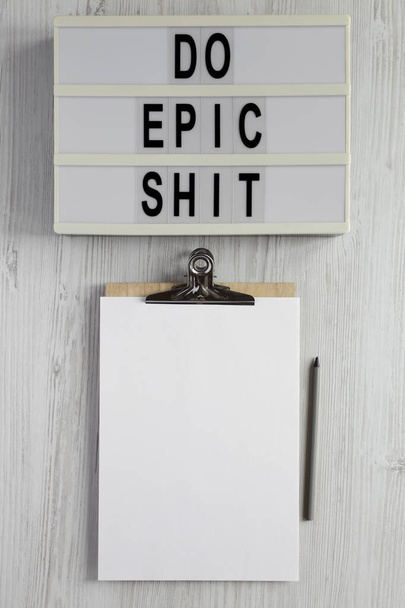 'Do epic shit' on a lightbox on a white wooden background, top view. Flat lay, overhead, from above.  - Foto, Imagem