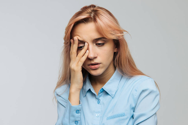 Displeased woman nearly falling asleep at work, hold her head with hand.Sleepy student spending time in university, feels lack of energy. Sleep deprivation, insomnia, apathy, weariness concept - Photo, image