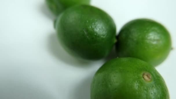 Close-up of fresh limes isolated on a white table - Footage, Video