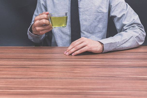 Business people drink tea at their desks - Фото, зображення
