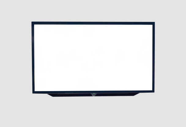 Black digital smart TV stuck on the house wall on gray background - Photo, Image