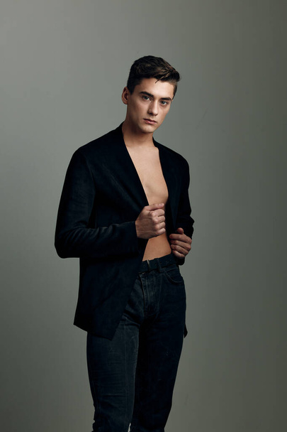 a man in an unbuttoned black jacket fashionable hairstyle - Photo, Image