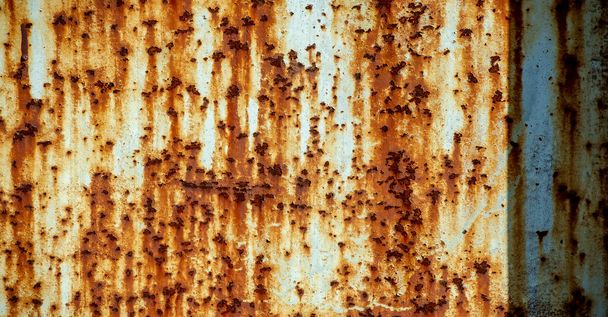 Rust on metal. Texture, background, pattern. When iron comes into contact with water and oxygen, it rusts. If salt is present, such as in seawater or salt spray, iron tends to rust more rapidly. - Photo, Image