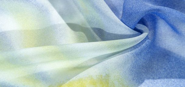 silk fabric in soft blue, yellow and white tones with abstract patterns and bed tones. Texture, pattern, collection - Photo, Image
