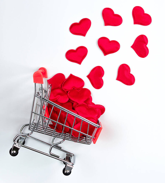 Supermarket trolley with hearts on white background. - Φωτογραφία, εικόνα