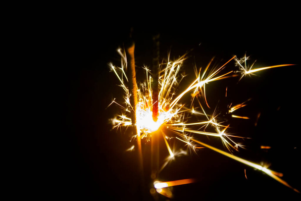 Firework, sparklers and bokeh lights on dark blue background - Foto, afbeelding
