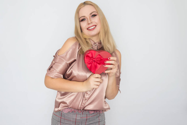 Valentines Day - dreaming woman in pink blouse holding red gift box heart - Fotoğraf, Görsel