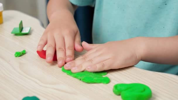 Primo piano di modellatura bambino e stampaggio argilla colorata o pasta in mano. Educazione dei bambini e sviluppo della cretività. - Filmati, video