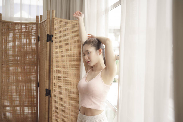Young asian beauty woman warm up before yoga exercise at home. - Photo, Image