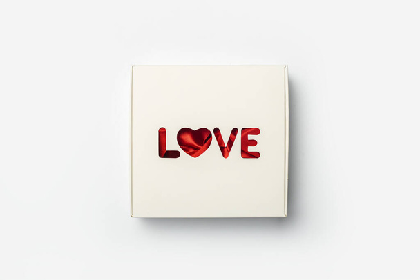 Gift box on a light white background. Composition Valentine's Day. Banner. Flat lay, top view. - Foto, Imagen