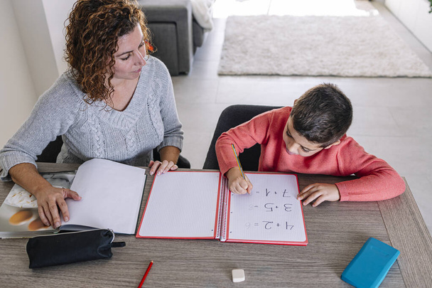 Mutter hilft Sohn beim Matheunterricht zu Hause - Foto, Bild