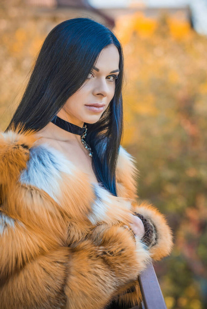 Woman in fox fur coat, choker on her neck . Concept of woman beauty and vintage fashion - Photo, Image