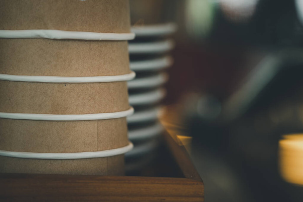 Rows of upside down brown cups of cardboard for hot coffee or hot tea in coffee shop - Photo, image