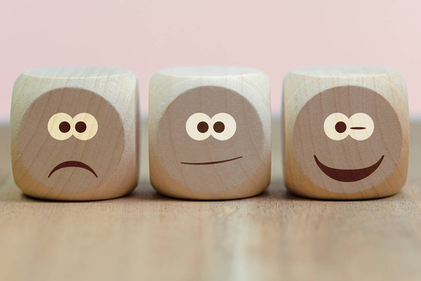 Emoticones con diferentes caprichos en tres cubos de madera - Foto, Imagen