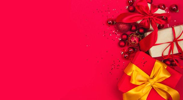 Christmas gifts and Christmas toys on a red background banner copy space - Фото, зображення