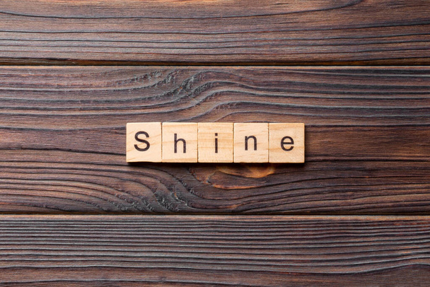 Shine word written on wood block. Shine text on cement table for your desing, concept. - Photo, Image