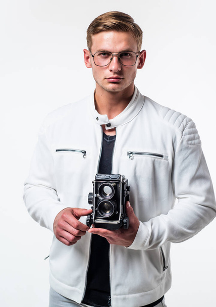 Desire meets new hobby. Handsome guy hold retro camera isolated on white. Young photographer wear glasses in casual style. Photography equipment. Hobby and lifestyle. Shooting session - Foto, afbeelding