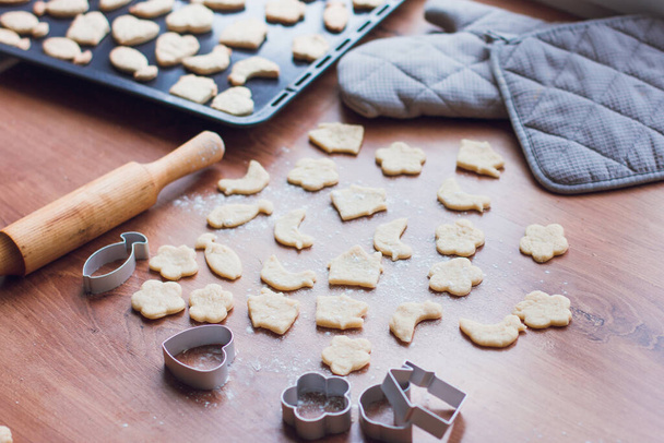 Cooking homemade cookies, dough and cookie cutters. Home-made food concept, insulation and new year's baking - Photo, image