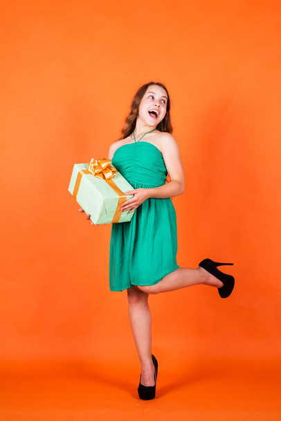 happy child with gift box on orange background, cyber monday - Foto, immagini