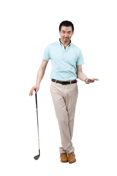 Young man wearing a suit and golfing - Fotó, kép