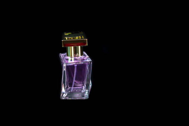 Elegant perfume bottle isolated on black background with copy space. - Foto, Imagen