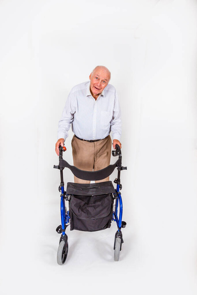 gelukkig senior man met rollator geniet van mobiliteit - Foto, afbeelding