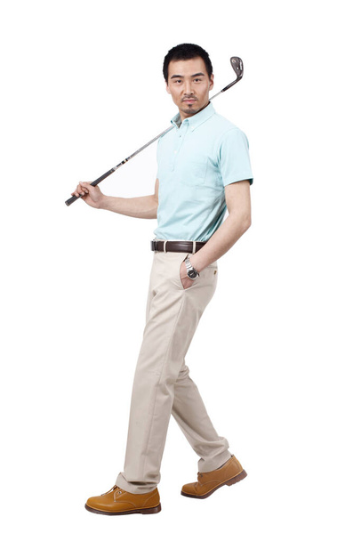 Young man wearing a suit and golfing - Foto, immagini