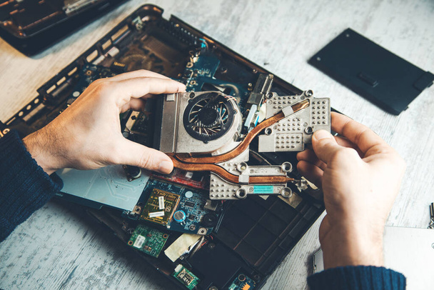 man hand computer processor with fan on the table - 写真・画像