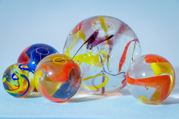 Glasmurmeln aus durchscheinendem Glas mit schönen farbigen Nebeln in den Glaskugeln, Kinderspielzeug - Foto, Bild