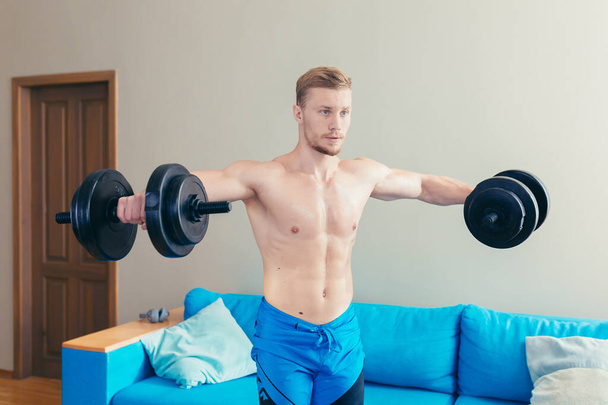 male athlete at home doing fitness on a kilik in the living room - Foto, Imagem