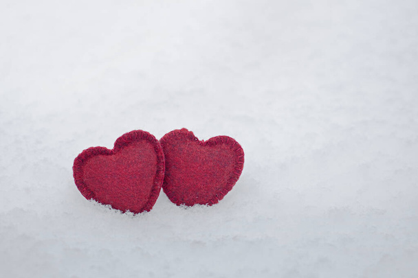 red felt hearts on white fluffy snow, mock up for Valentine's day card, free space, love and fidelity concept - Valokuva, kuva