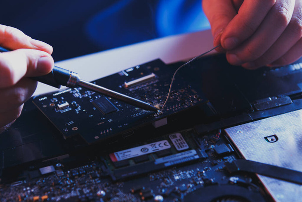 PC technology .Computer repair shop. Engineer performing laptop maintenance. Hardware developer fixing electronic components. - Фото, изображение