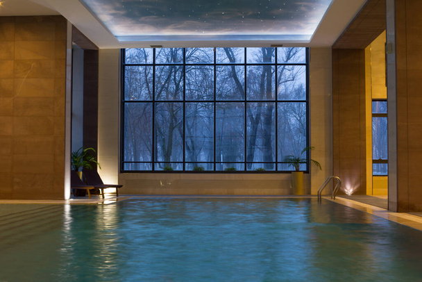 beautiful pool with panoramic windows on  winter evening - Foto, Imagem